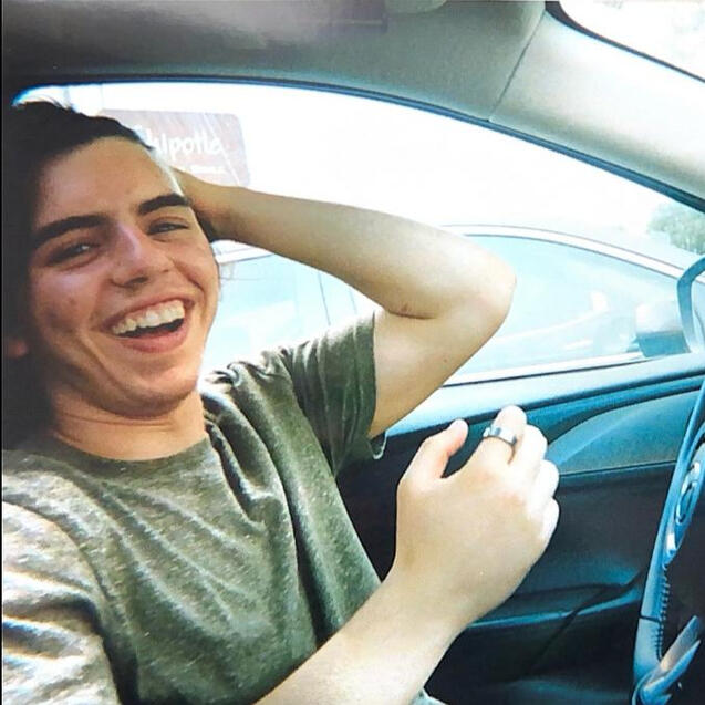 Piper, laughing in the front seat of his car.