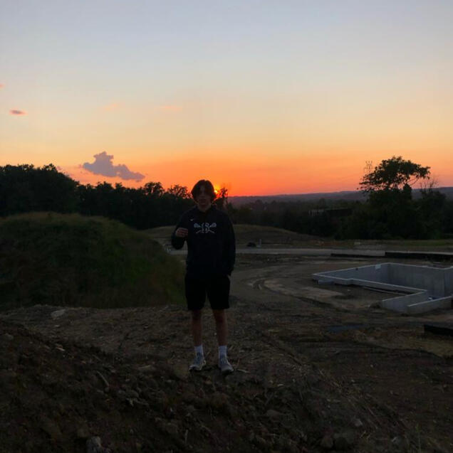 Piper, standing in front of a sunset.